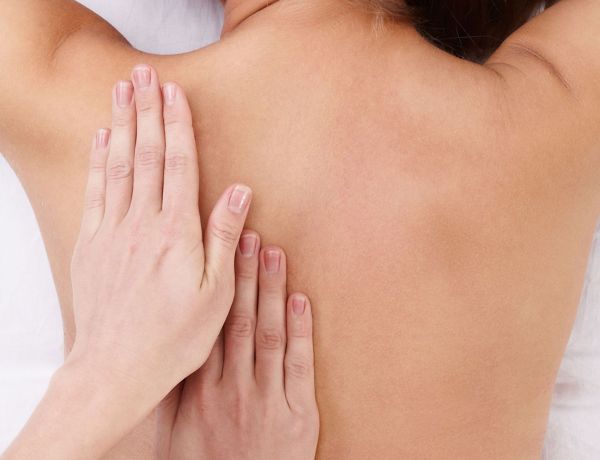 Frau genießt entspannende Rückenmassage als Teil eines Wellness- und Entspannungsangebots in Berlin